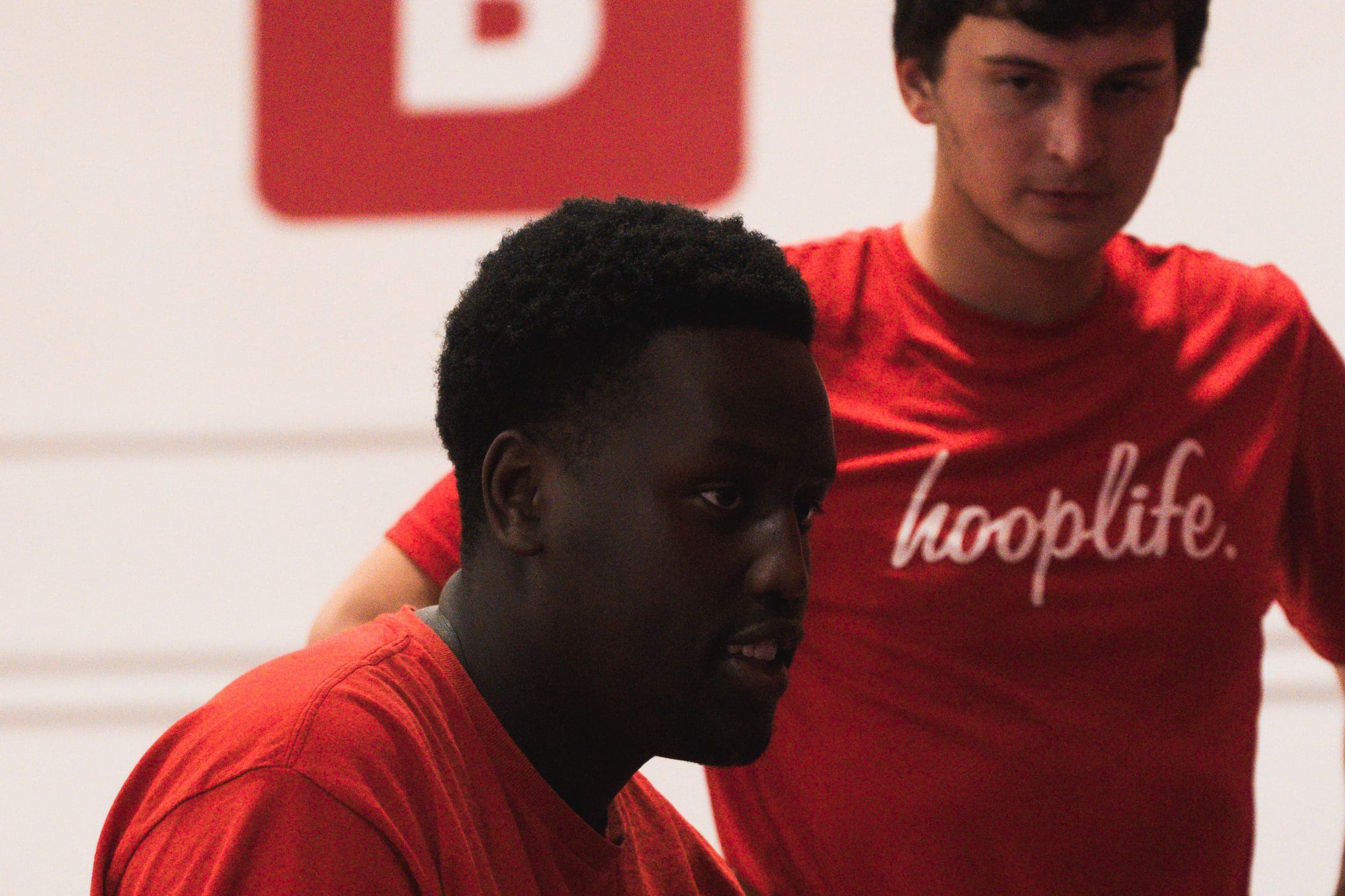 A HoopLife coach working closely with a single player in Regina