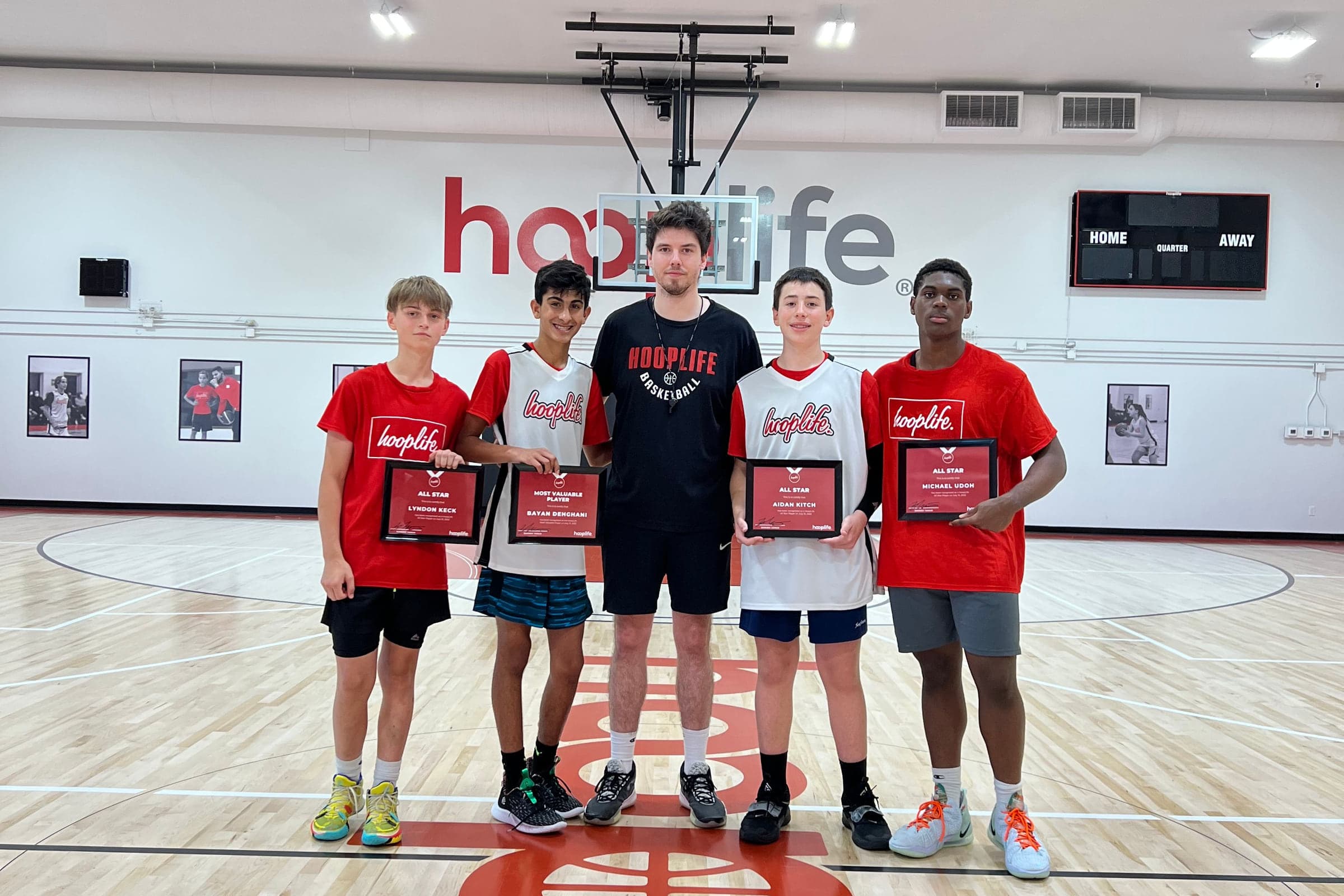 HoopLife players holding their awards at centre court in Regina