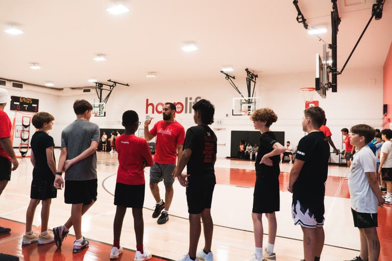 A HoopLife coach running a skills session with players on the Regina court