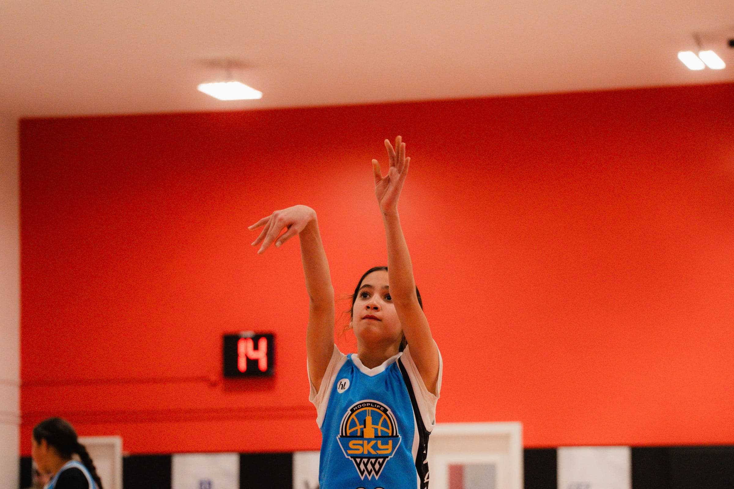 A young player following through on a jump shot at HoopLife in Regina