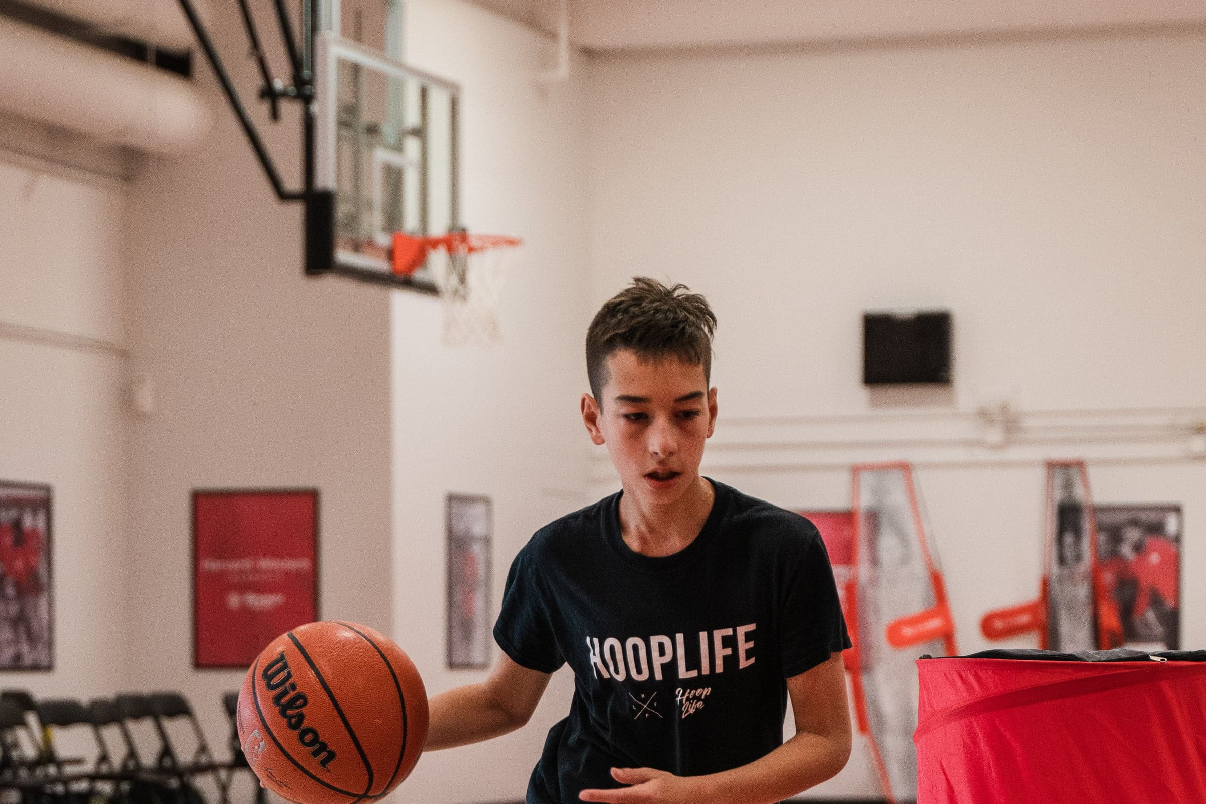 A teenager working on his ball handling at the HoopLife Centre in Regina