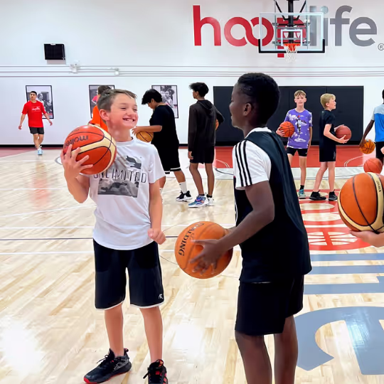 A group of HoopLife campers laughing on the court in Regina