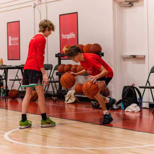 Two HoopLife players working through a dribbling drill at the facility