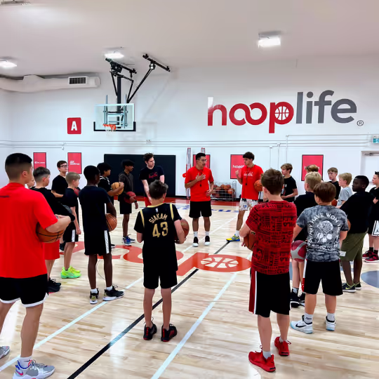 HoopLife kids gathered on the court listening to their coaches