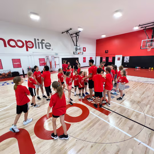 A group of young HoopLife players on the court at the Regina facility