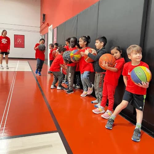 Young Stars kids lined up against the wall at HoopLife