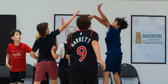 Kids jumping for a basketball