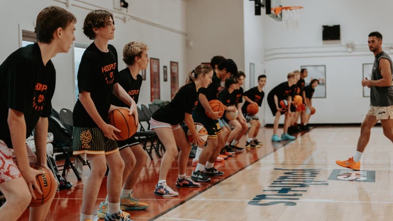 A line of players in stance at the start of a HoopLife training session