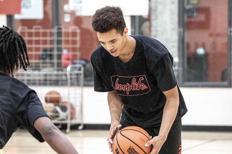 A HoopLife coach working with a camper in the training room
