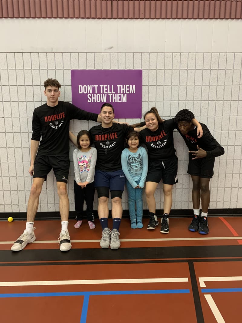 HoopLife coaches and Kinistin campers under the Don't Tell Them Show Them banner