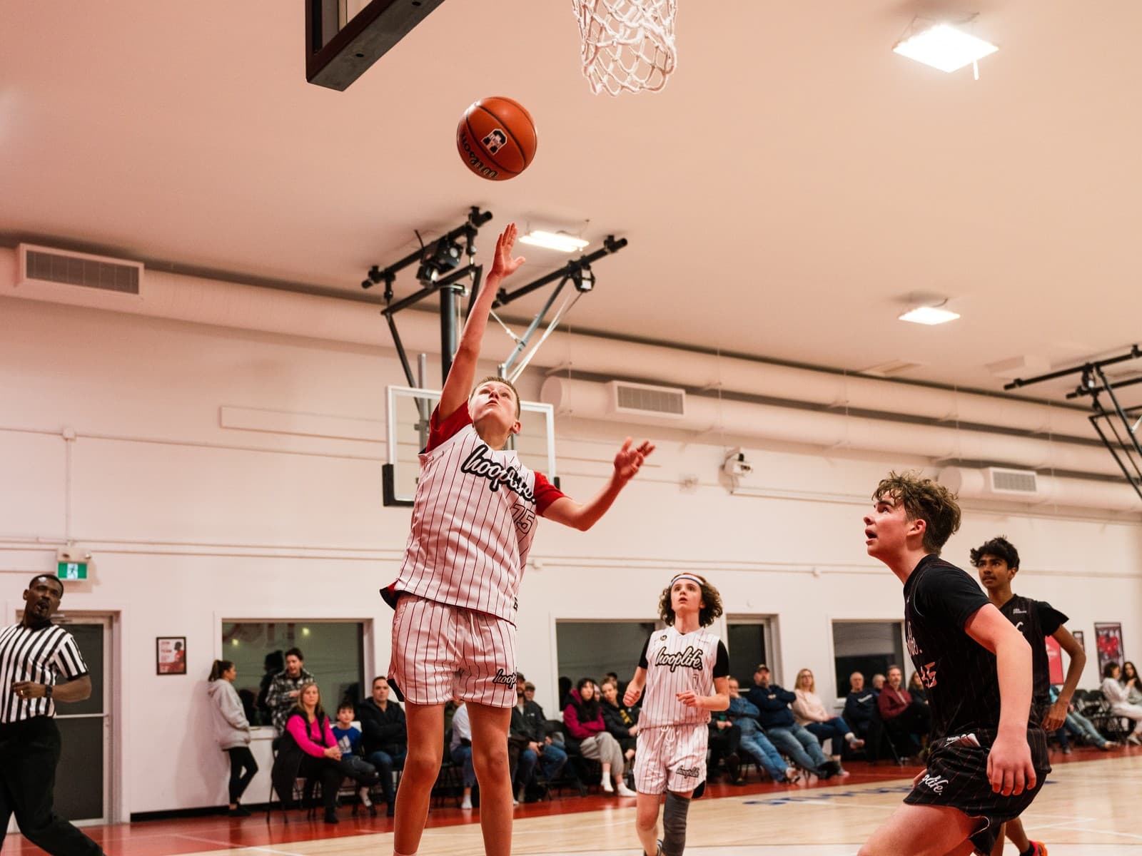 A girls division player finishing at the rim