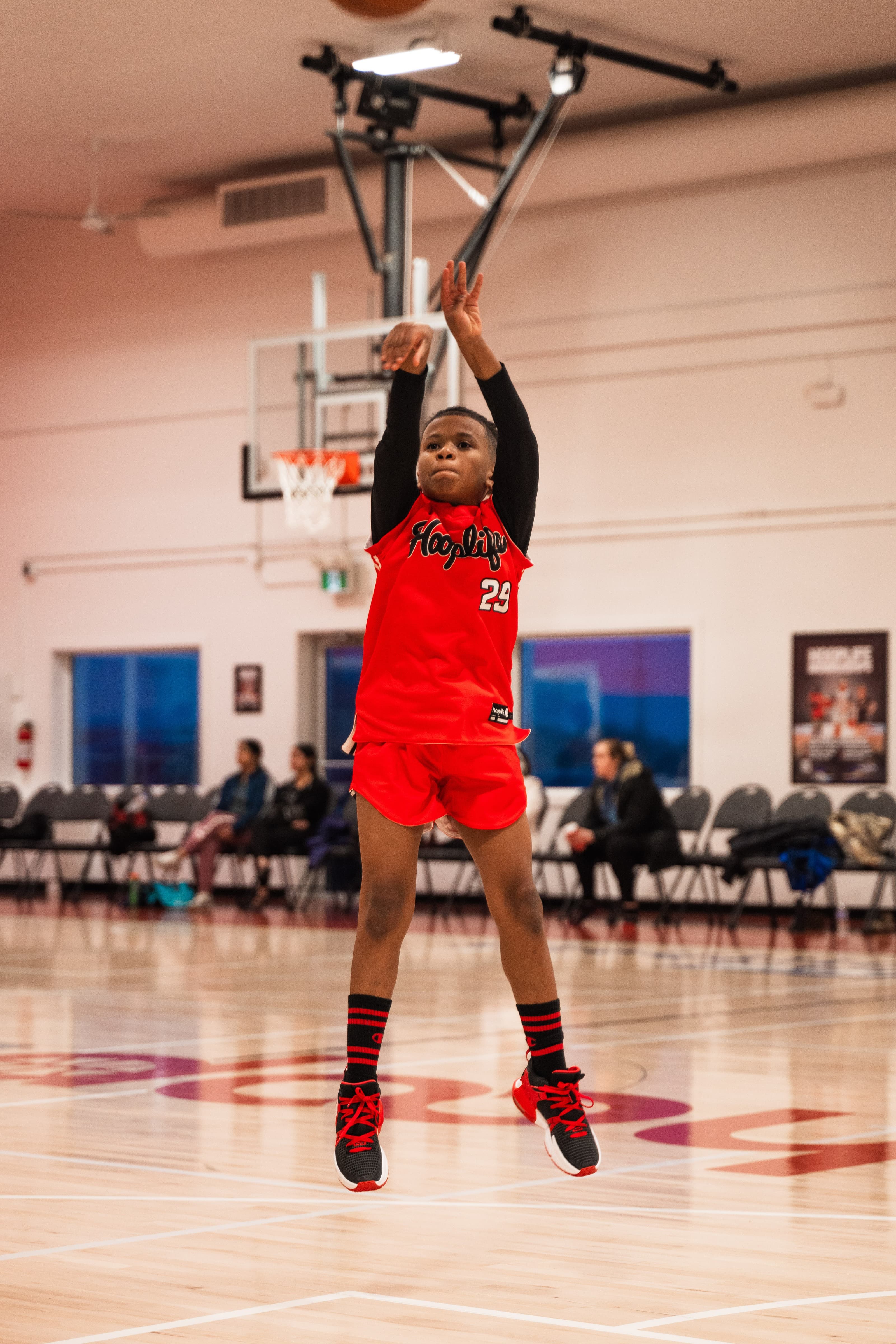 A young player shooting at HoopLife open gym in Regina
