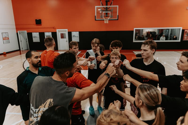 Players with their hands in with the pros to close a clinic