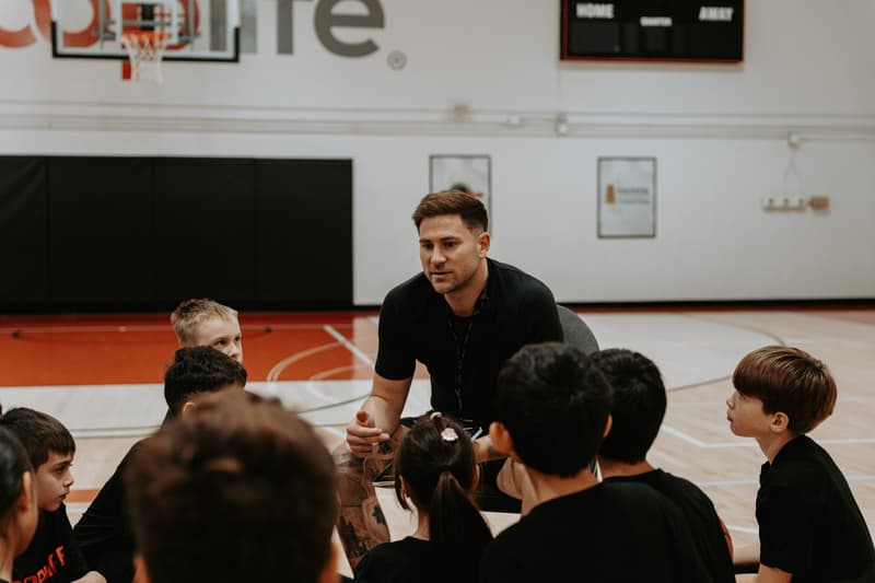 Marek Klassen kneeling with campers during a break