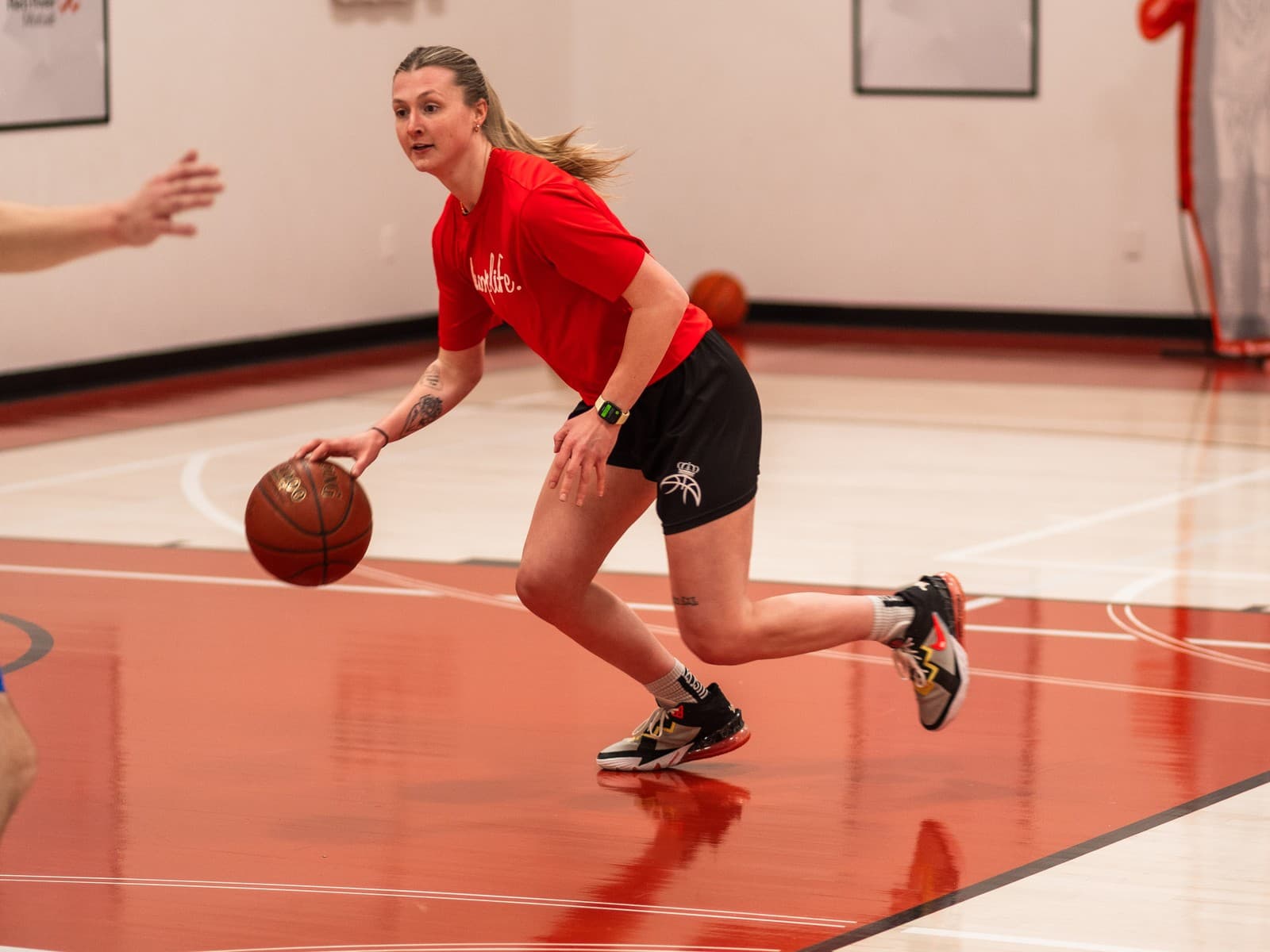 A player bringing the ball up the red court