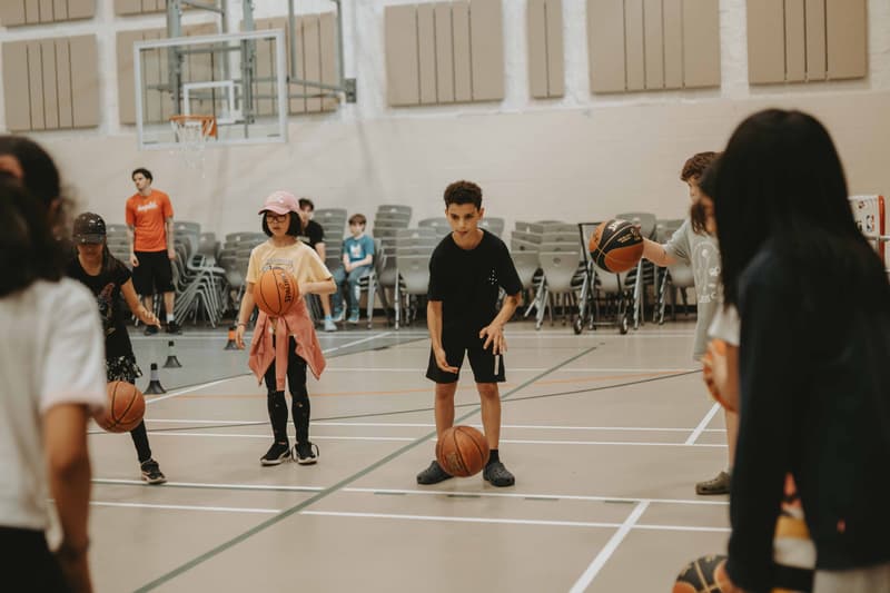 Kids working through ball-handling drills at a HoopLife community clinic