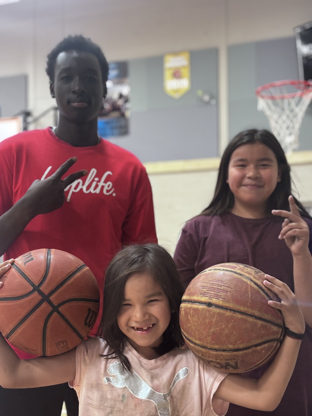 A HoopLife coach with a group of girls at a community clinic