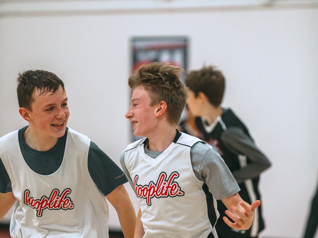 HoopLife League teammates sharing a laugh mid-game
