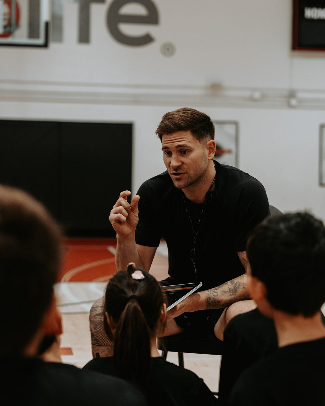 Canadian pro Marek Klassen crouched down talking to kids at a HoopLife clinic