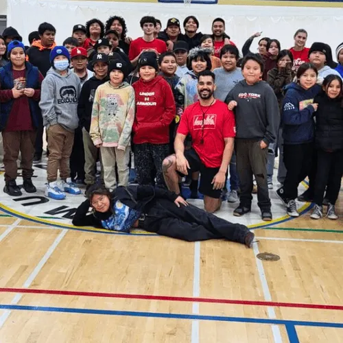 A school group with their HoopLife coach after a small-town clinic