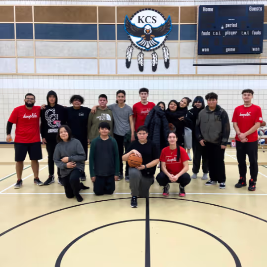 A community group with HoopLife coaches at the end of a clinic