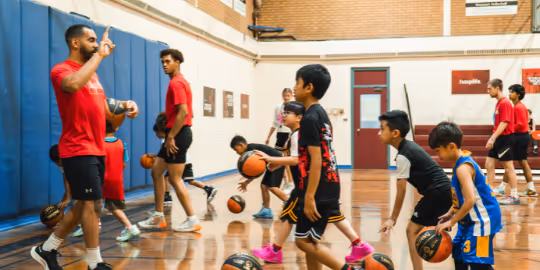 Kids running with basketballs at HoopLife