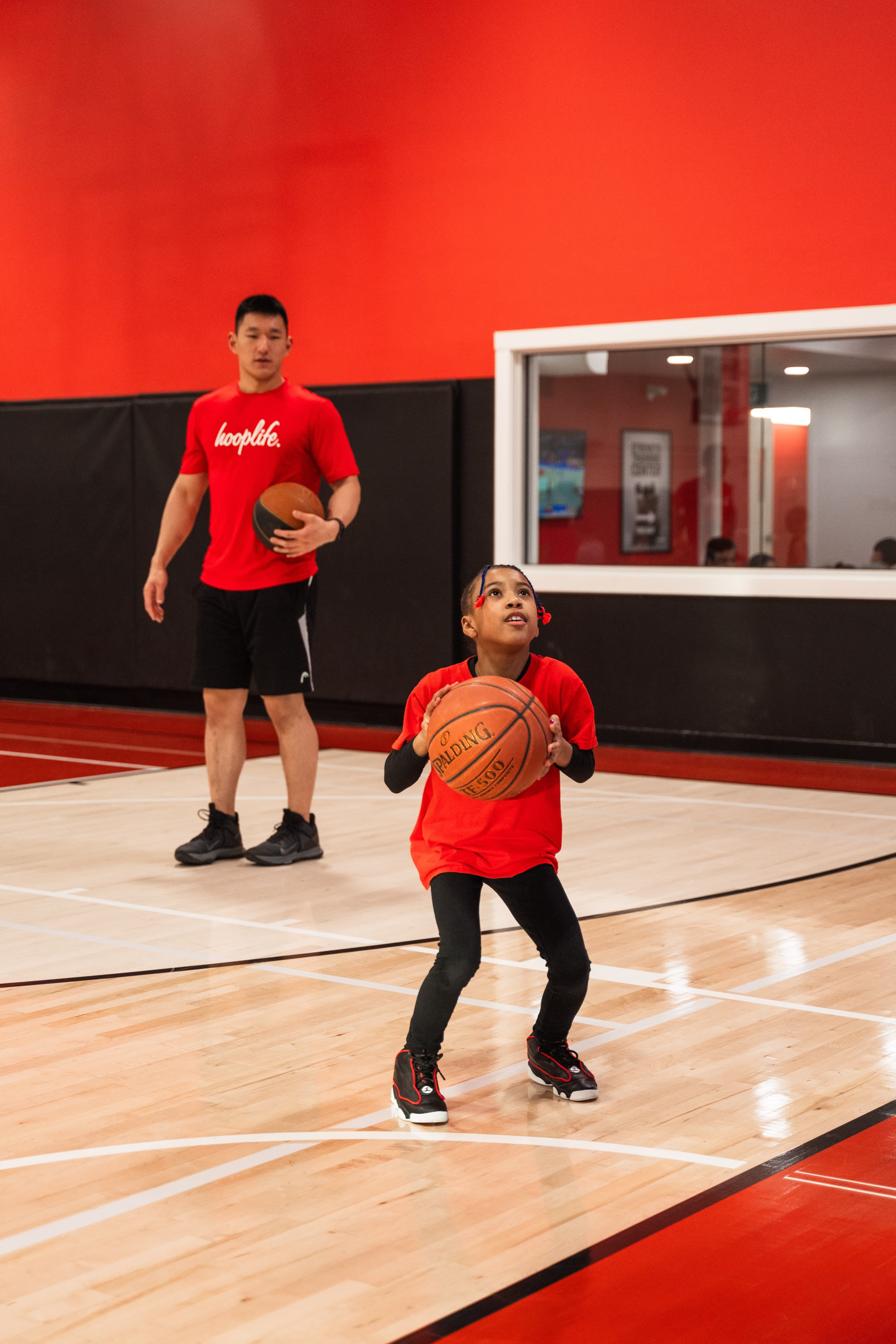 A HoopLife coach working one-on-one with a young player