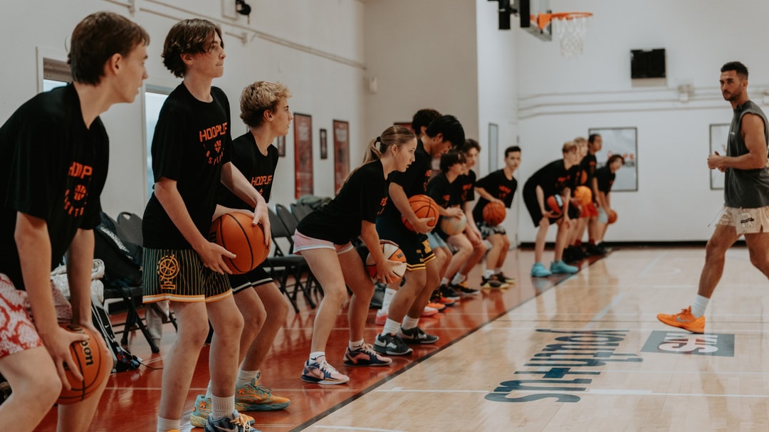 Pro trainer Jordan Lawley running a HoopLife session with players lined up in stance