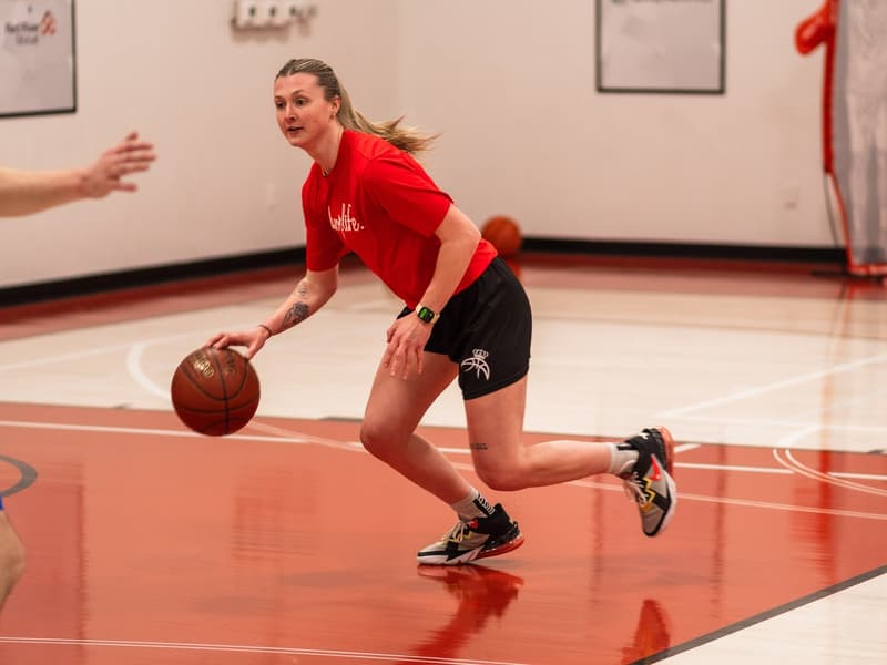 A camper dribbling across the red court in Regina