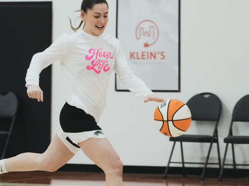 A camper pushing the ball on the break at the HoopLife Centre