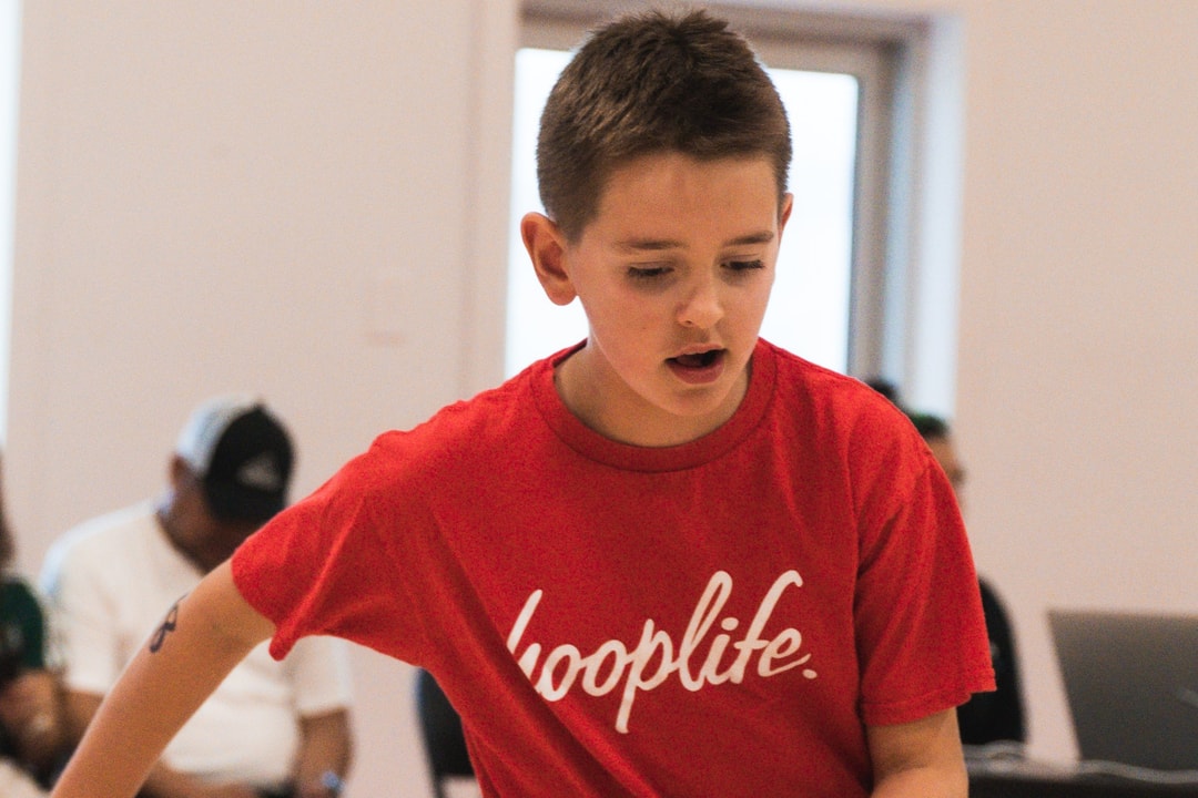 A summer camper working through a dribbling drill