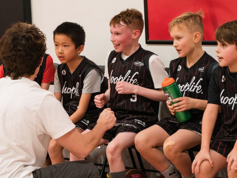Camp teammates together on the bench at the HoopLife Centre
