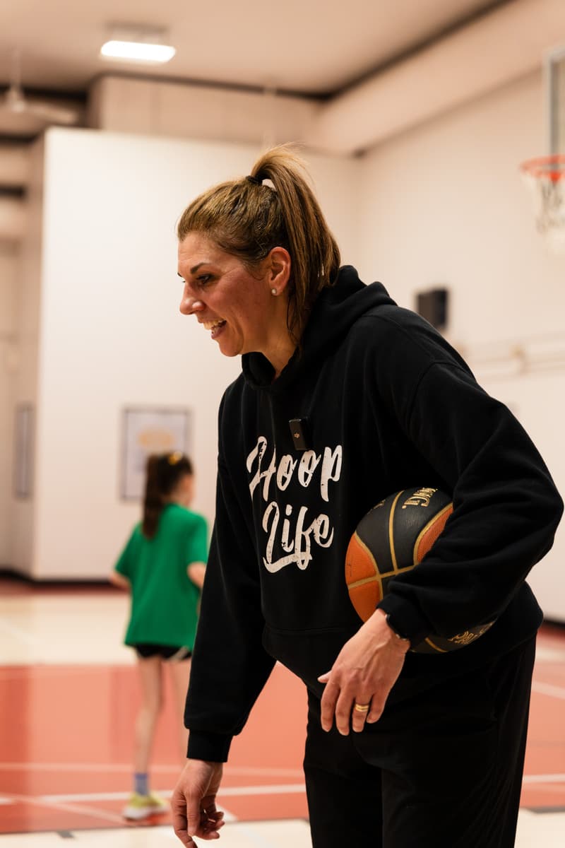A woman coach with her group at a girls only session