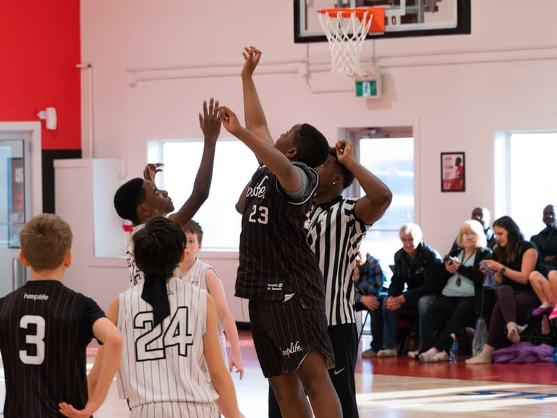 HoopLife League players battling for a rebound at the rim