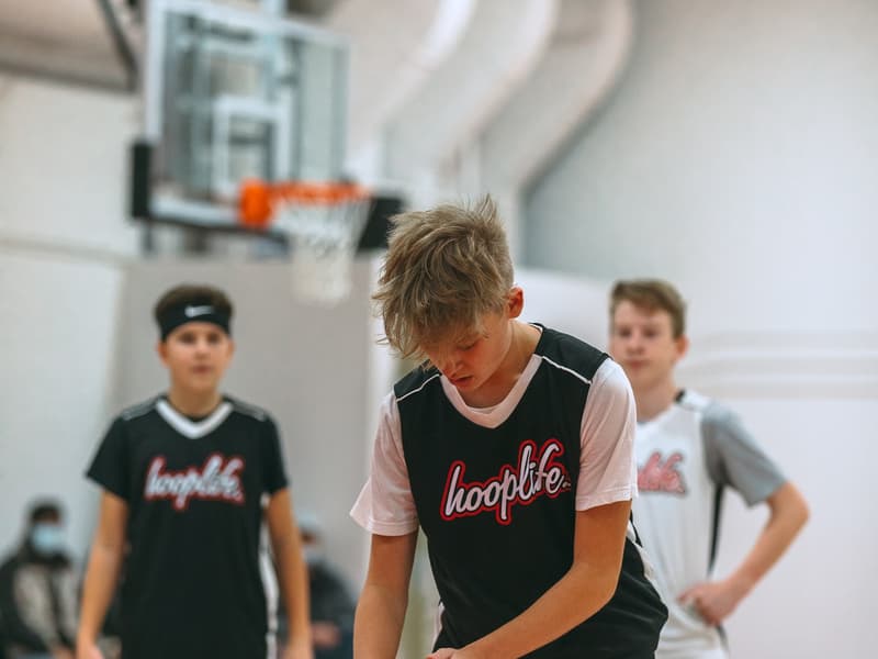 Two HoopLife League teams battling for the ball on game night