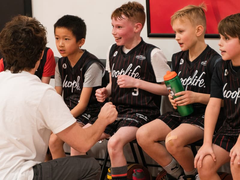 Players hanging out on the bench at open gym