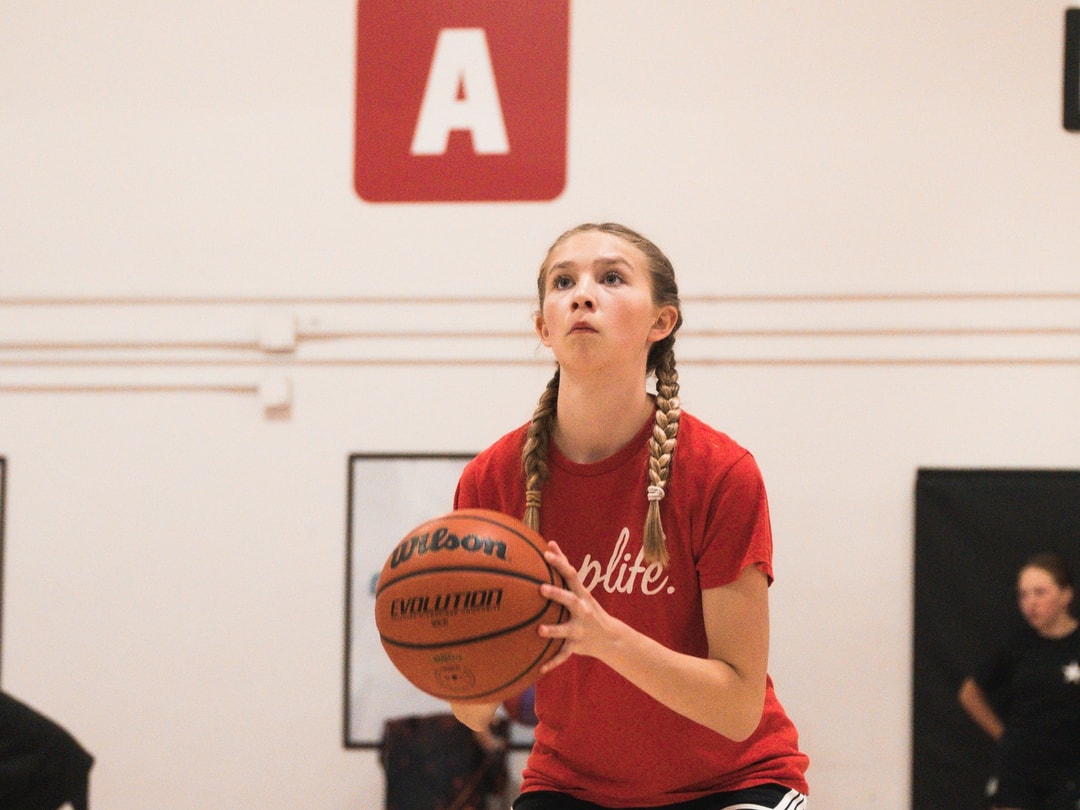 A player working on her shooting form at a HoopLife session