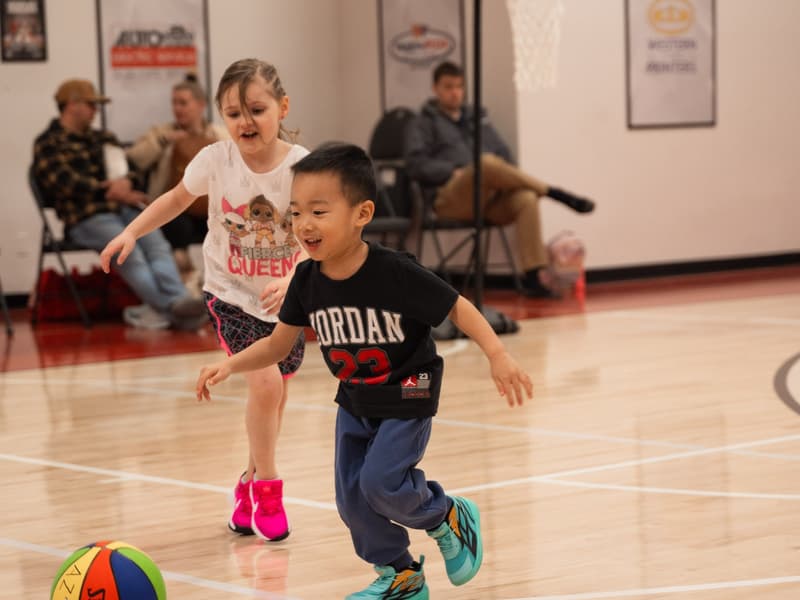 Two Young Stars boys dribbling side by side