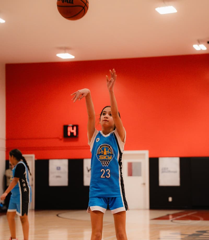 A player rising into a jump shot on the HoopLife court