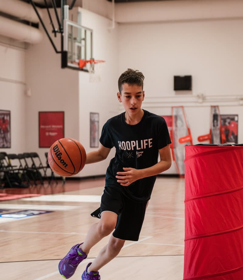 A player driving hard past a defender at the HoopLife Centre